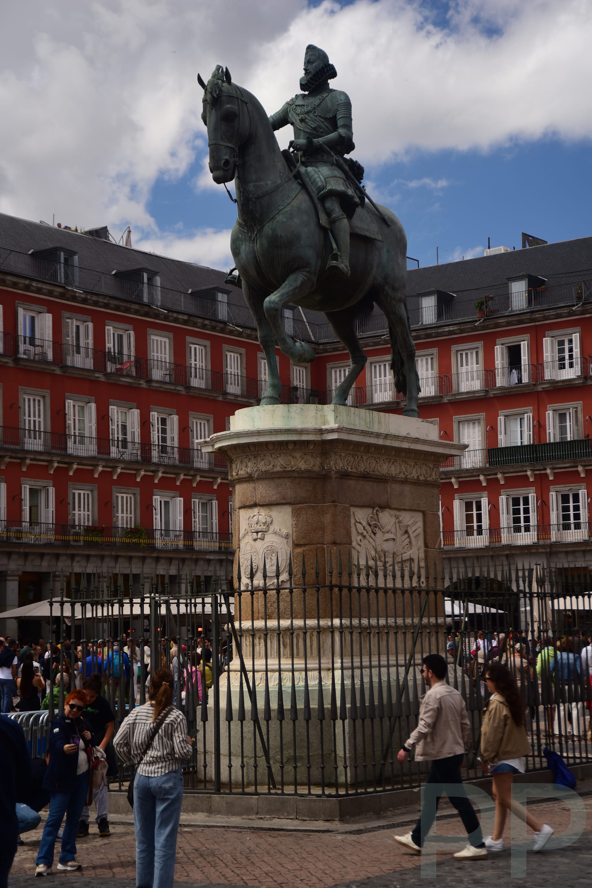 Equestrian statue of King Philip III in Plaza Mayor, Madrid, with the red surrounding façades.