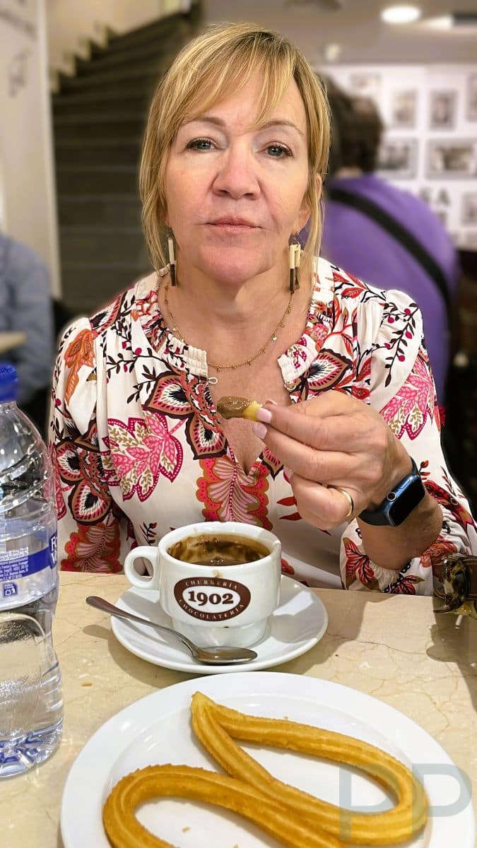 Plate of churros with thick hot chocolate for dipping in Madrid.