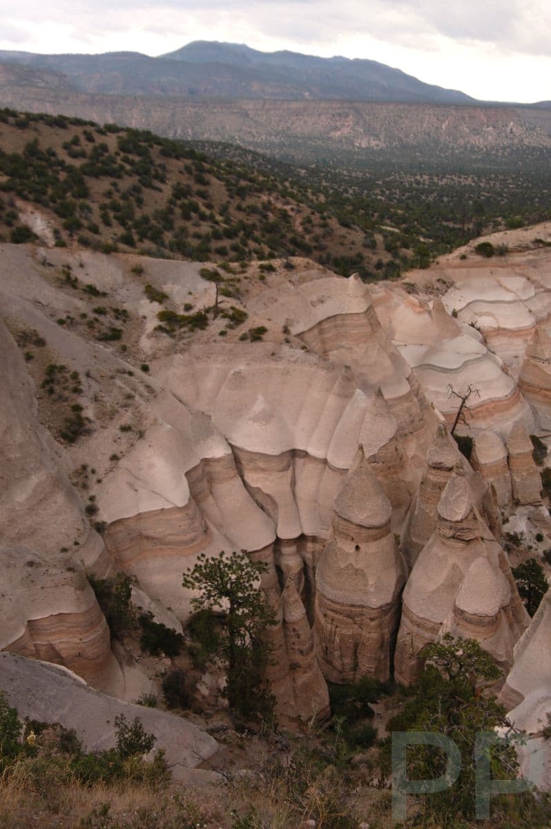Tent-shaped rock formations clustered in a canyon at Kasha-Katuwe Tent Rocks National Monument