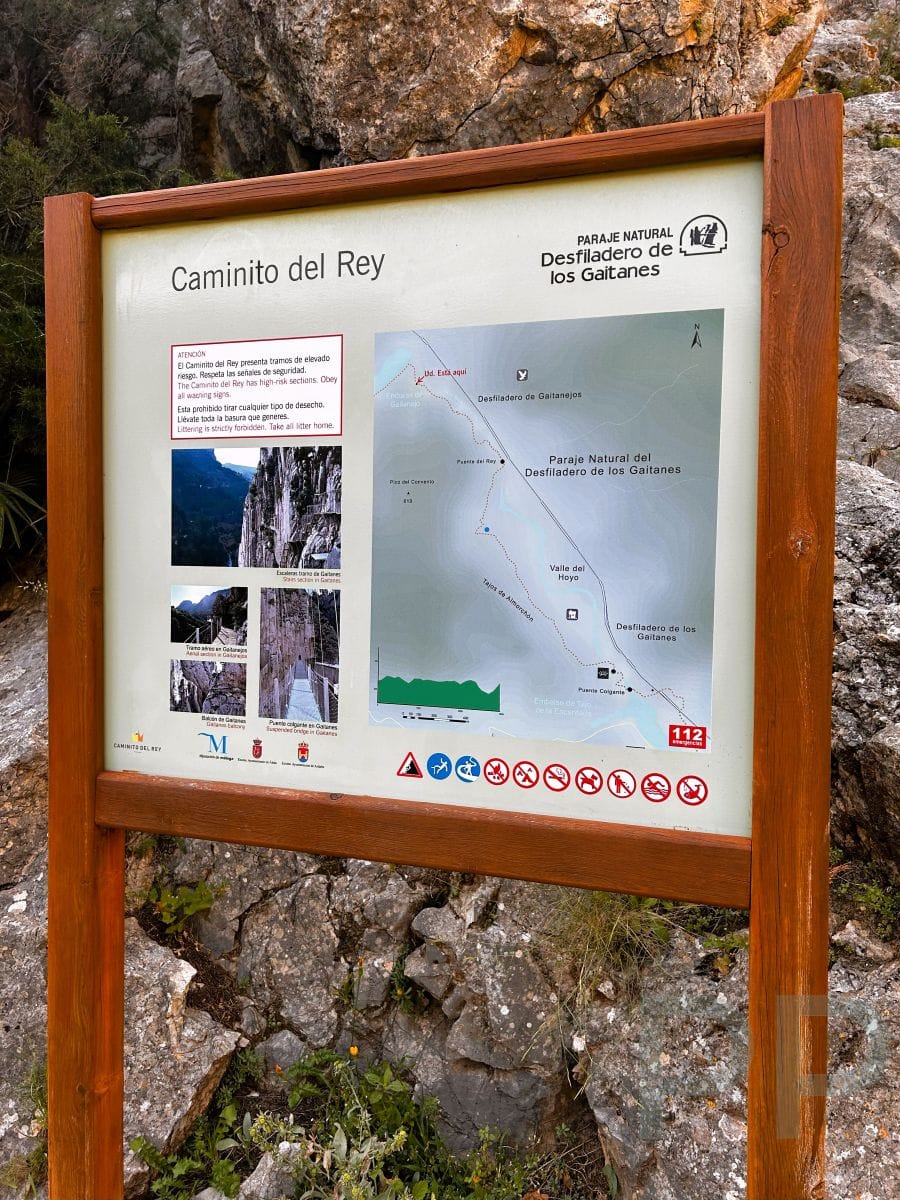 Trail information board for the Caminito del Rey in Spain, showing a map of the Desfiladero de los Gaitanes and safety warnings.
