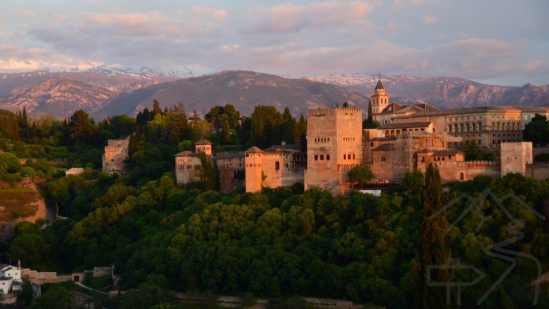 Alhambra viewed from Mirador de San Nicol&aacute;s at sunset with the Sierra Nevada in the background.