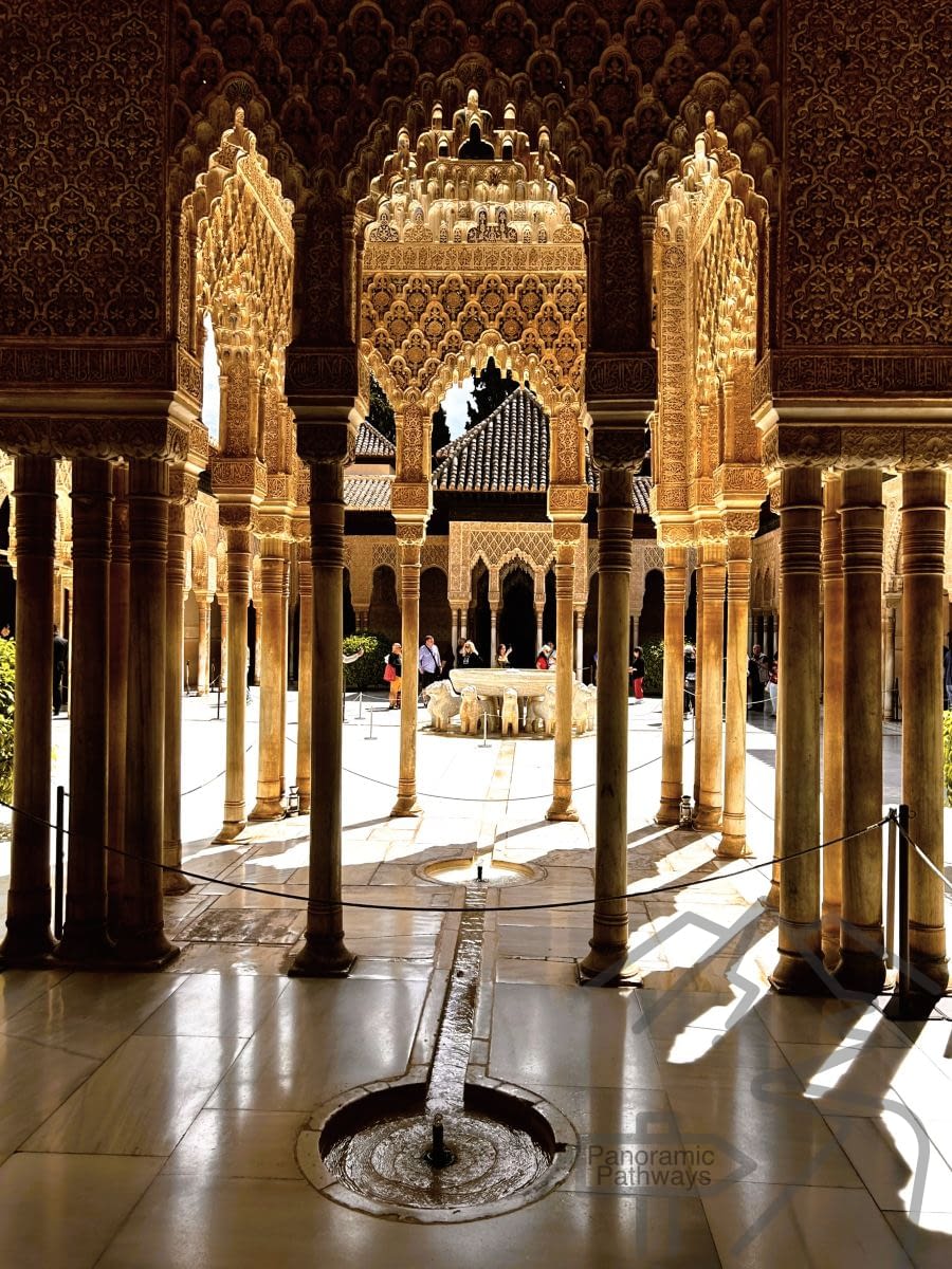 Interior courtyard or hall in the Nasrid Palaces with arches, columns, and decorative stucco.