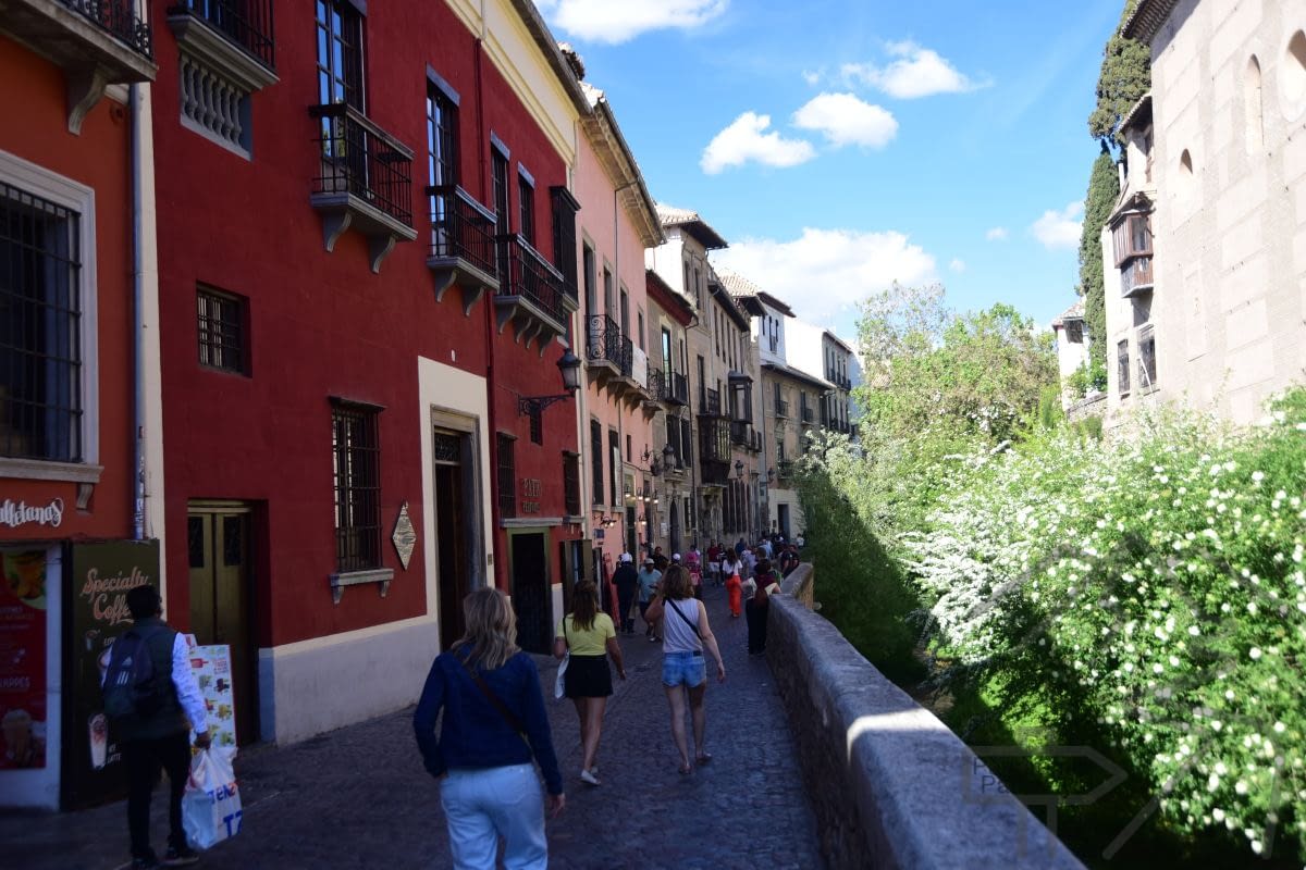 Carrera del Darro in Granada beside the Darro River with historic buildings and stone walkways.